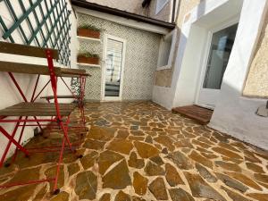 a bench sitting on a stone floor next to a building at APARTAMENTO LUCÍA Y ALISA in Inogés