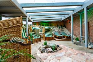 a patio with chairs and a fire pit at ambassador hotel & spa in Sankt Peter-Ording