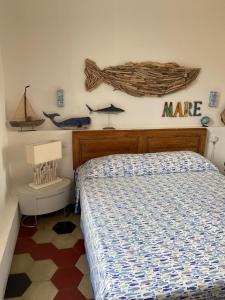 a bedroom with a bed and a sign on the wall at Le Stanze sul Mare in Portoferraio