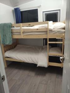 two bunk beds in a room with a wooden floor at Holiday Retreat in Burbank