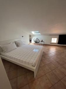 a bedroom with a large bed in a room at B-Guest House in Oristano
