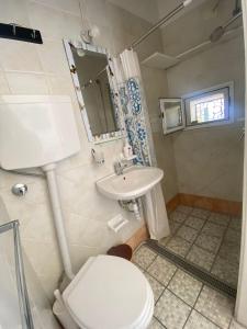 a bathroom with a toilet and a sink at Casa Rita in Piazza Marina in Ischia
