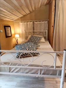 a bed with a metal frame in a room at o le zen in Saint-Juire-Champgillon