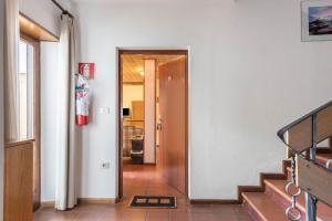 a hallway with a stairway leading to a room at Pension Sonia App 102 in Funes