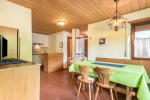 a kitchen and dining room with a table and chairs at Pension Sonia App 102 in Funes