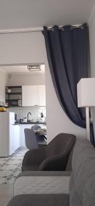 a living room with a couch and a kitchen at Apartament Klonowa in Poznań +49 photos