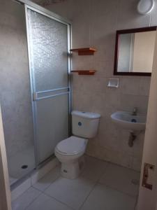 a bathroom with a toilet and a shower and a sink at Tucuma Casa Hotel in Leticia