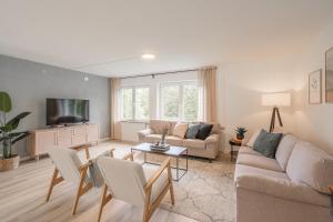 a living room with a couch and a tv at Villa Hoheneck in Wildemann
