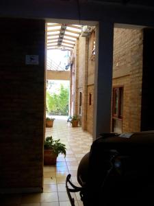 a hallway of a building with a table and a chair at DEPARTAMENtO LOFT in Posadas