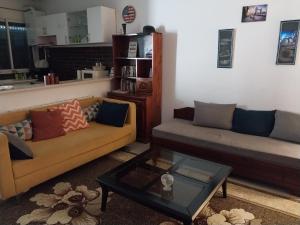 a living room with two couches and a coffee table at Silverwood in Tunis