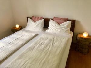 a bedroom with two beds with white sheets and pillows at Gerwies-Hof in Bronzolo