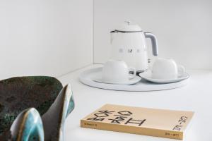 a pair of shoes and a tea pot and a box at Vila Maria Hotel - Adults Only in Albufeira