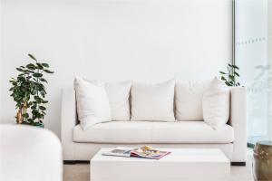 a white couch in a living room with a coffee table at Vila Maria Hotel - Adults Only in Albufeira