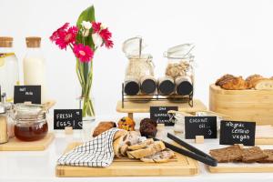 a table with various types of bread and pastries at Vila Maria Hotel - Adults Only in Albufeira