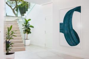 a hallway with stairs and a painting on the wall at Vila Maria Hotel - Adults Only in Albufeira