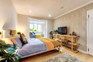 a bedroom with a large bed and a television at Braemor 4 bedroom villa, all en-suite in Arrochar