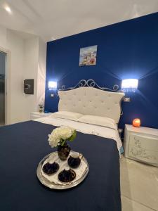 a bedroom with a bed with a blue wall at Samcri Luxury Home in Catania
