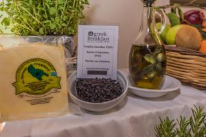 a table with a bottle of cheese and a bowl of food at Sea View Village in Vasilikos