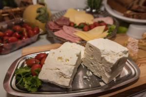 a plate of food with cheese and fruit on a table at Sea View Village in Vasilikos