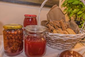 a table with jars of food and a basket of nuts at Sea View Village in Vasilikos