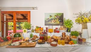a table topped with lots of different types of food at Sea View Village in Vasilikos