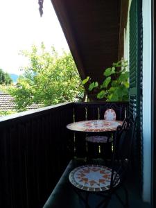 a table and two chairs on a porch with a table and a table at Haus Huber in Übersee