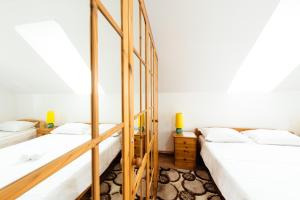 two beds in a room with white walls at Casa VLC Punct Gastronomic Local Bilbor in Rocoteaş