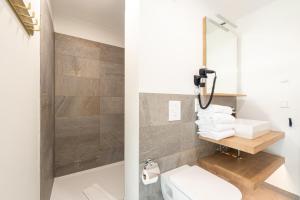 a bathroom with a toilet and a mirror at Design Apartments Potsdam - Luise in Potsdam