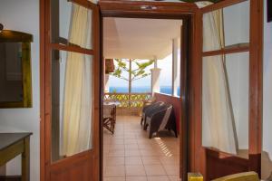 a door leading into a room with a view of the ocean at Sea View Village in Vasilikos