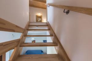 a staircase in a room with a blue chair at Sea View Village in Vasilikos
