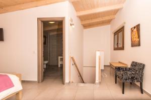 a bedroom with a bed and a table and a chair at Sea View Village in Vasilikos