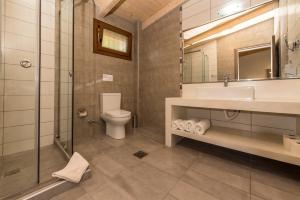 a bathroom with a toilet and a sink and a shower at Sea View Village in Vasilikos