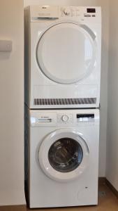 a white washer and dryer in a room at PORT CITY HAIFA - Beach front luxury apartment - MAMAK in Haifa