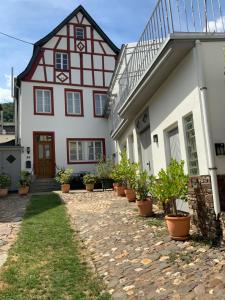a house with potted plants in front of it at Ferienhaus Mosel 2.0 in Bremm
