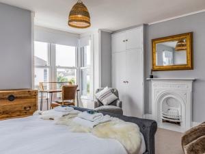 a bedroom with a bed and a fireplace at Pass the Keys Delightful 2 Bed House a Stones Throw From Beach in Bognor Regis