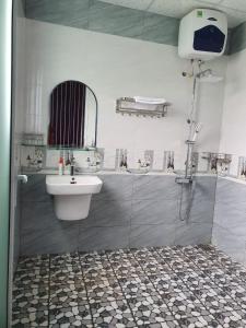 a bathroom with a shower with a sink and a shower at Tea Garden House in Xã Tân Phát