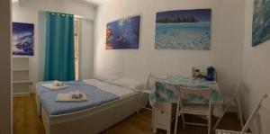 a small bedroom with a bed and a table at Sunshine Apartment in Rome