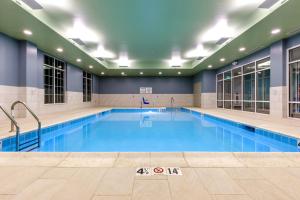 a large swimming pool in a building at Holiday Inn Express & Suites - Sturbridge, an IHG Hotel in Sturbridge