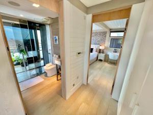 a room with a bedroom with a bed and a mirror at The Beach Hytte - Stunning Sea View Penthouse in Bournemouth