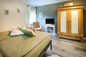 a bedroom with a bed and a tv and a cabinet at Bei Fritz und Frieda in Willingen