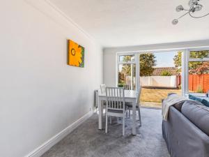 a living room with a table and chairs and a couch at Pass The Keys Lovely Ground Floor Flat With Large Garden in Chichester