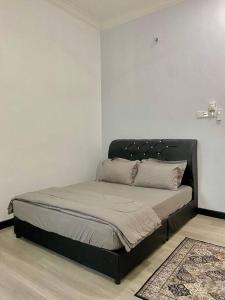 a bed in a corner of a room at Homestay Ummi D'Pauh in Kota Bharu