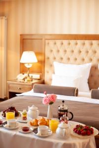 a hotel room with a table with breakfast foods on it at Nadiya Hotel in Ivano-Frankivsk