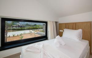 A bed or beds in a room at Fairytale Villas