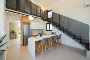 a kitchen with a white counter and a staircase at Fairytale Villas in Souda