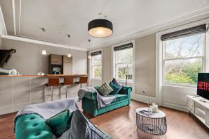 a living room with a couch and a table at The Sleek Gem of Central Wakefield - Parking in Wakefield