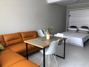 a living room with a couch and a table and a bed at RELAX Apartments in HASKOVO, Apt2 in Haskovo