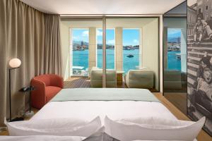 a hotel room with a bed and a view of the water at Hotel Ambasador in Split