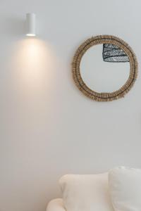 a mirror hanging on a wall next to a couch at Casa Boma Lisboa - Shining & Spacious Apartments With Balcony - Alvalade I in Lisbon