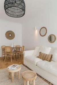 a living room with a white couch and a table at Casa Boma Lisboa - Shining & Spacious Apartments With Balcony - Alvalade I in Lisbon
